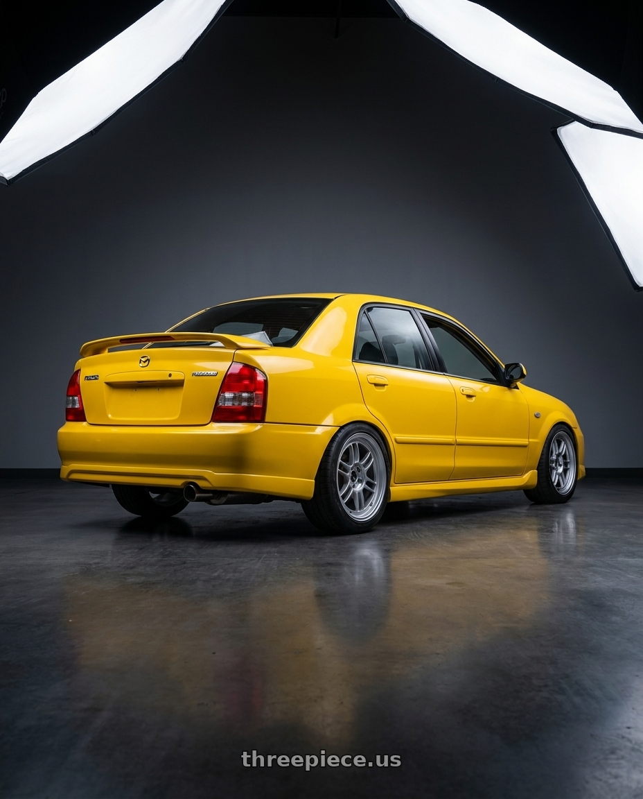2003 Mazda Protege Mazdaspeed with Enkei RPF1 5x114.3 17x7.5+48 Silver wheels rear three quarter view square tires