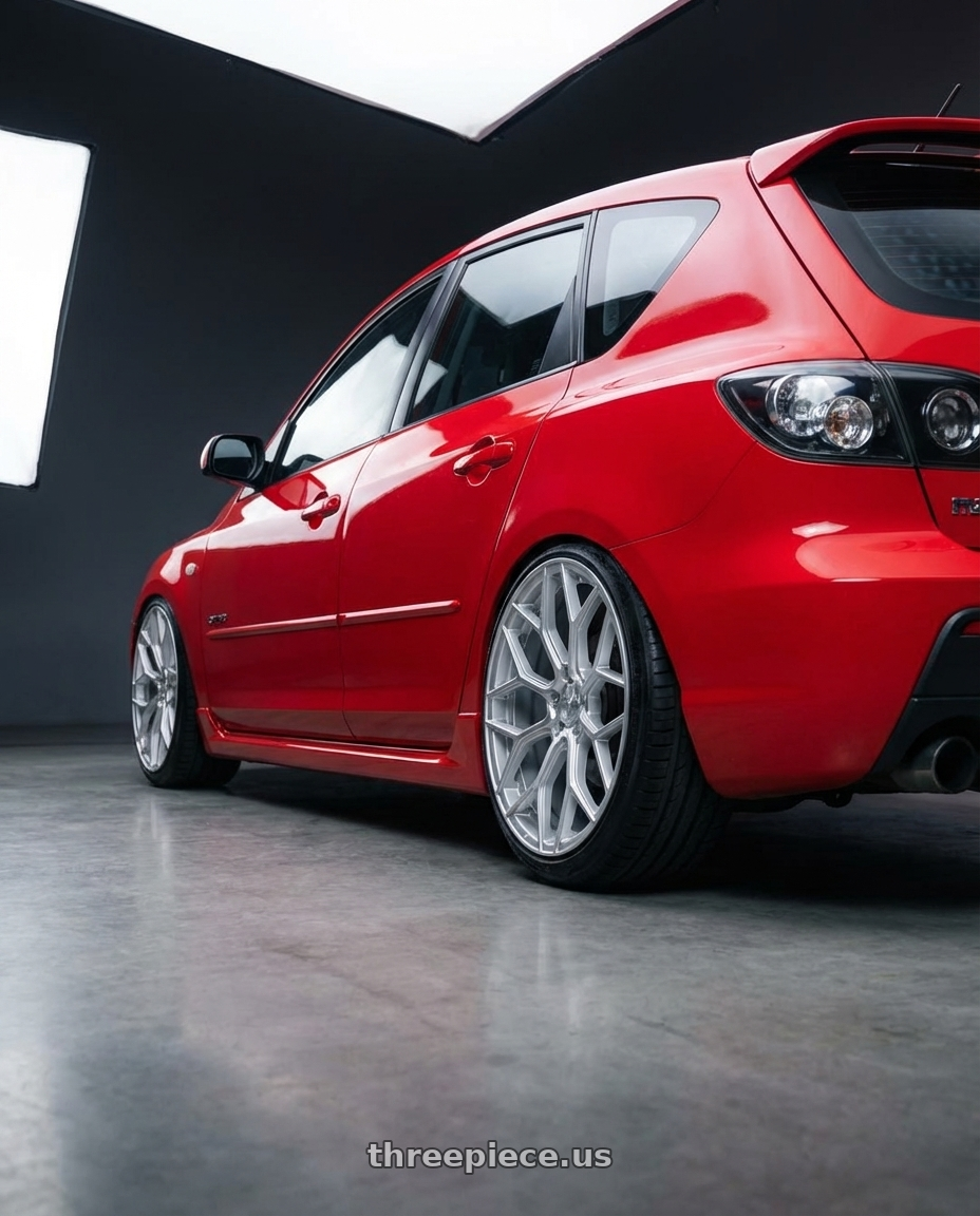 2008 Mazda 3 SP23 with DOLCE PERFORMANCE PISTA 5x112 18x8.5 +35 Gloss Silver Machined Face wheels rear three quarter view slight stretch tires