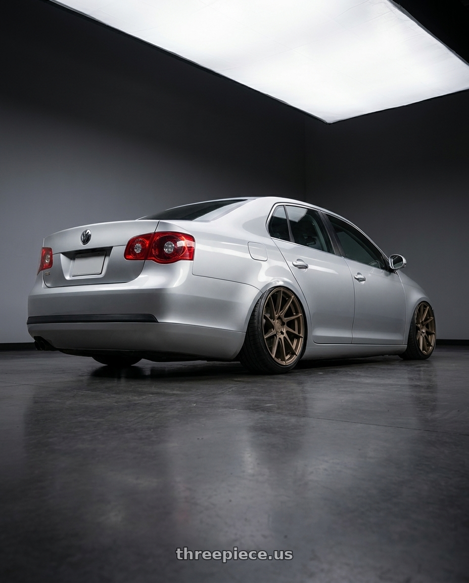 2009 Volkswagen Jetta GLI MK5 with Aodhan AH09 5x112 18x8.5 +35 Matte Bronze wheels rear three quarter view slight stretch tires