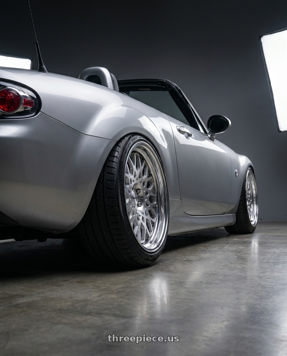 2007 Mazda Miata with Work Seeker Cx 4x100 18x10.5+38 R Disk Matte Silver Polish wheels rear three quarter view extreme stretch tires