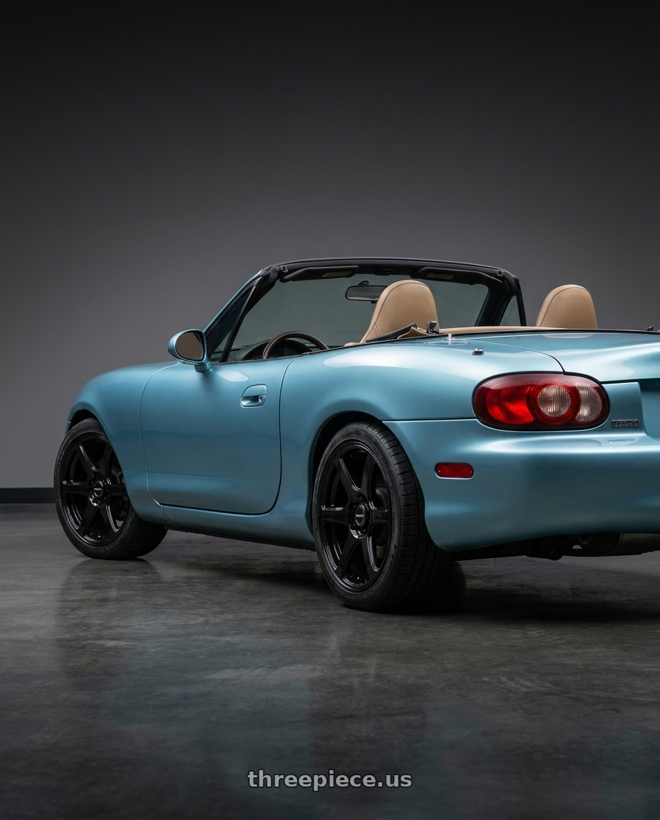 2002 Mazda Miata with Raceline 146B Matrix 4X100/4x114.3 15x7 40 Gloss Black wheels rear three quarter view square tires