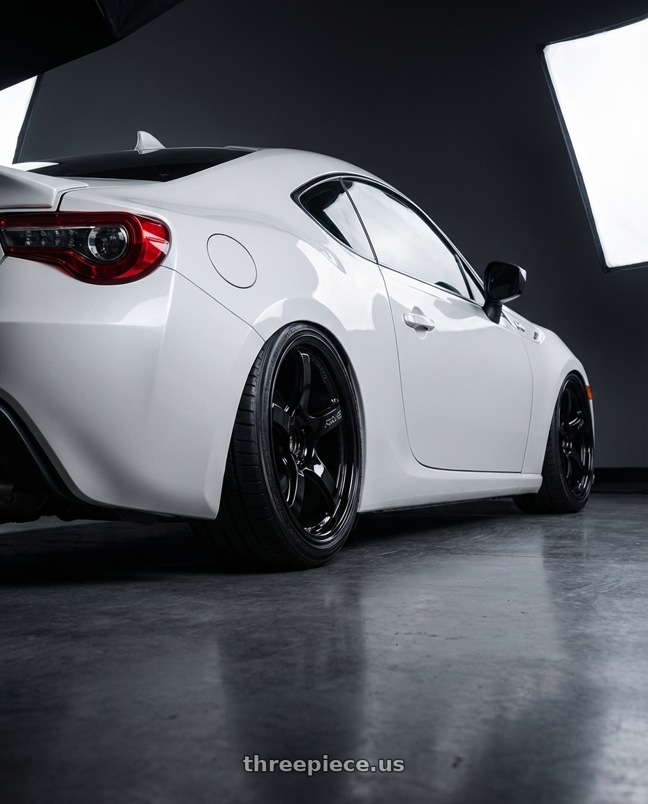 2016 Scion FR-S with Gram Lights 57CR 5x100 18x9.5+38 Glossy Black wheels rear three quarter view slight stretch tires