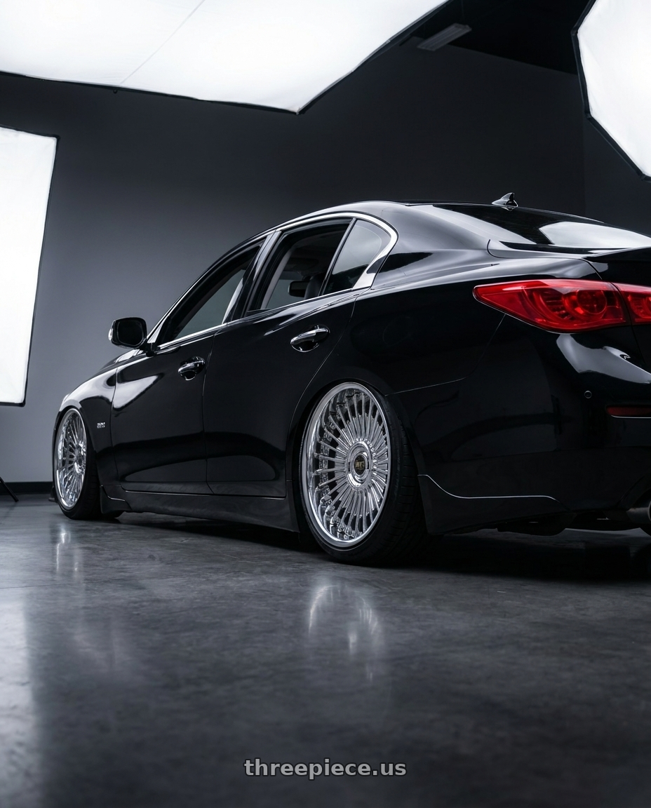 2017 Infiniti Q50 with Work Emitz Chrome 5x114.3 19x9.5 +45 wheels rear three quarter view slight stretch tires