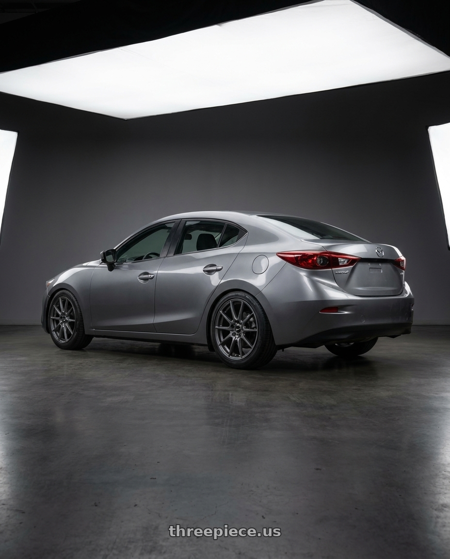 2014 mazda 3 with V�xx Capo 5x108/5x114.3 17x7.5+38 Carbon Grey wheels rear three quarter view square tires
