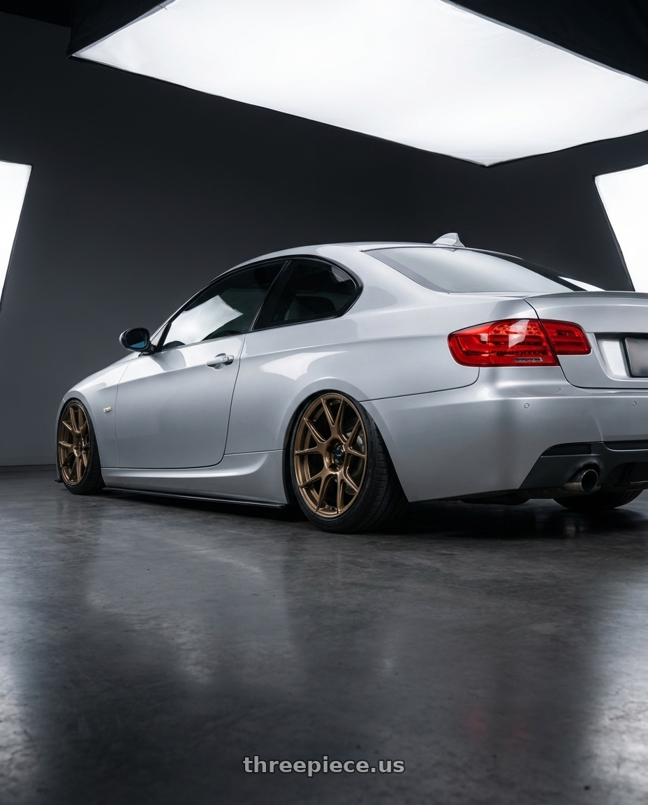 2012 BMW 3 Series E92 with Konig Ampliform 5x120 18x8.5+32 Gloss Bronze wheels rear three quarter view slight stretch tires
