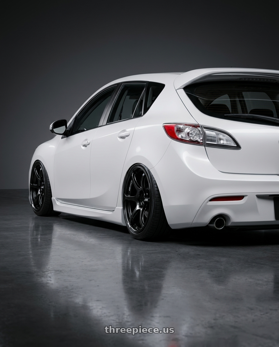 2012 Mazda Mazdaspeed3 with Advan RGIII 5x114.3 18x9.5+45 Gloss Black wheels rear three quarter view slight stretch tires