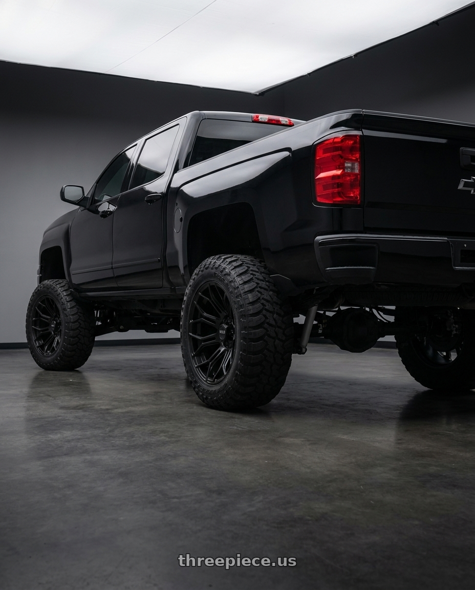 2015 Chevy Silverado 1500 LT with WELD Off-Road Gradient 5x139.7 20x10 -18 Satin Black wheels rear three quarter view square tires