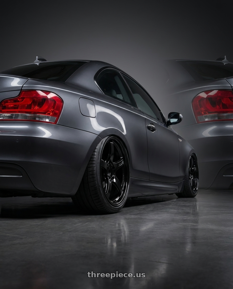 2012 BMW 1 Series E82 with Gram Lights 57CR 5x120 19x9.5+25 Glossy Black wheels rear three quarter view slight stretch tires