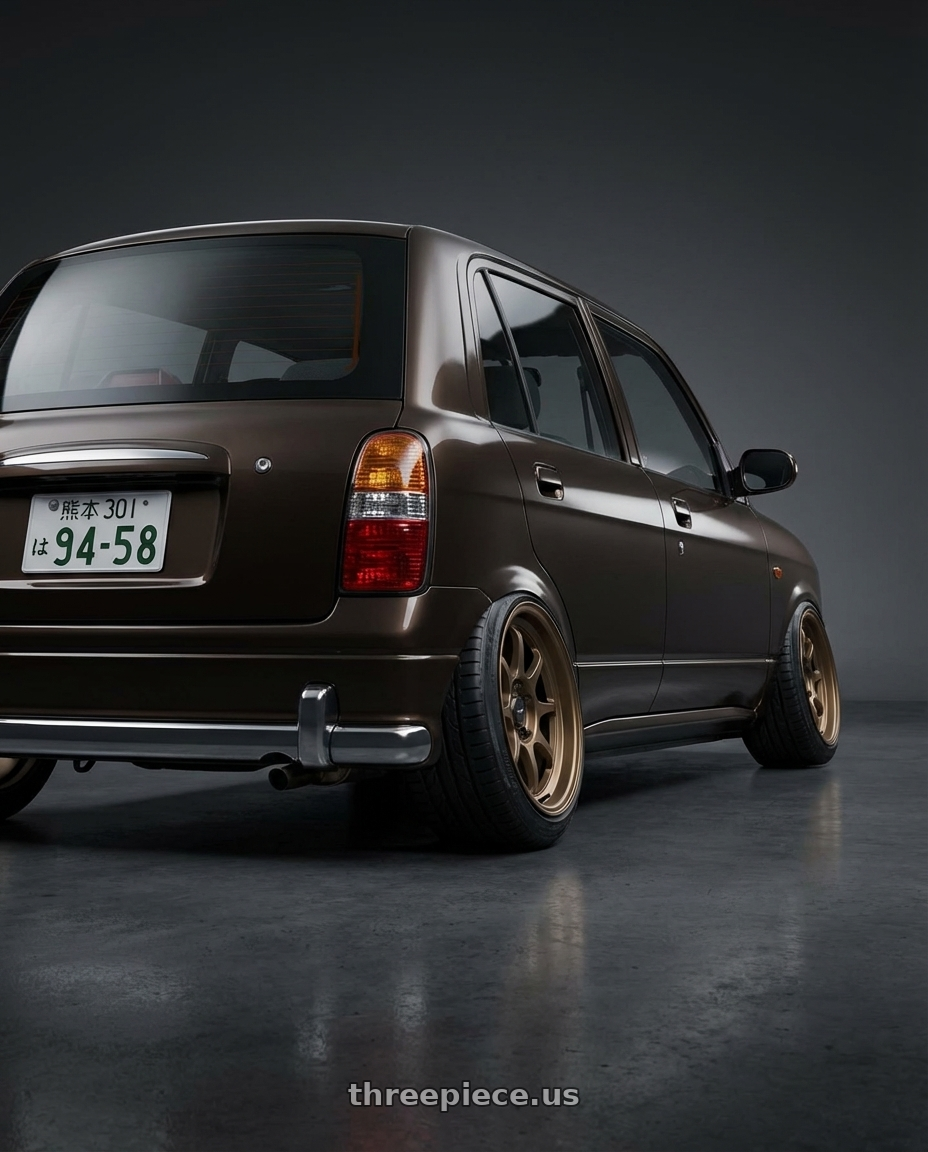 2000 Daihatsu Mira Gino  with Konig Helium 4x100 15x6.5+40 Bronze wheels rear three quarter view slight stretch tires