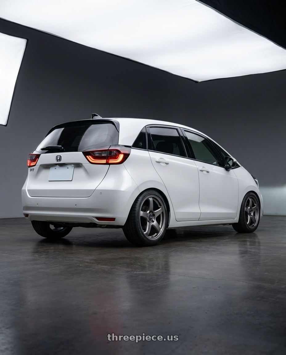 2025 honda fit4 with Enkei PF05 4x100 17x7+45 Dark Silver wheels rear three quarter view square tires