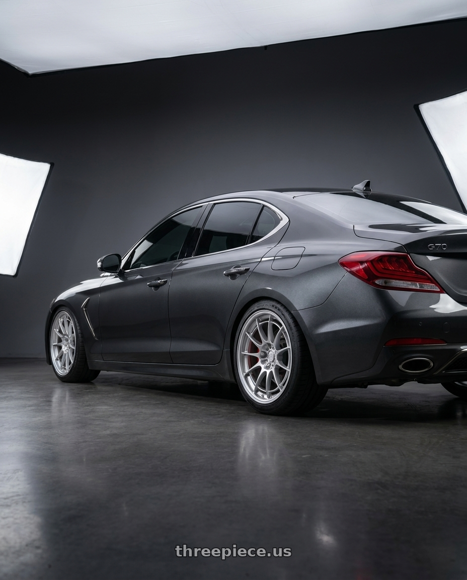 2019 Genesis G70 with Enkei NT03+M 5x120 18x8.5+38 Silver wheels rear three quarter view slight stretch tires