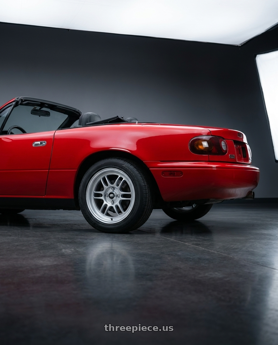 1992 mazda miata with MST Wheels Suzuka 4X100 15x7.0 +33 Glossy Silver wheels rear three quarter view square tires