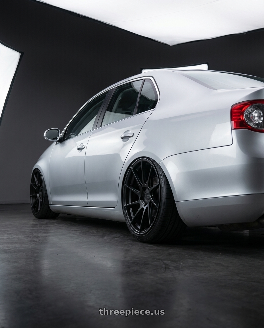 2009 Volkswagen Jetta GLI MK5 with Aodhan AH09 5x112 18x8.5 +35 Matte Black wheels rear three quarter view slight stretch tires