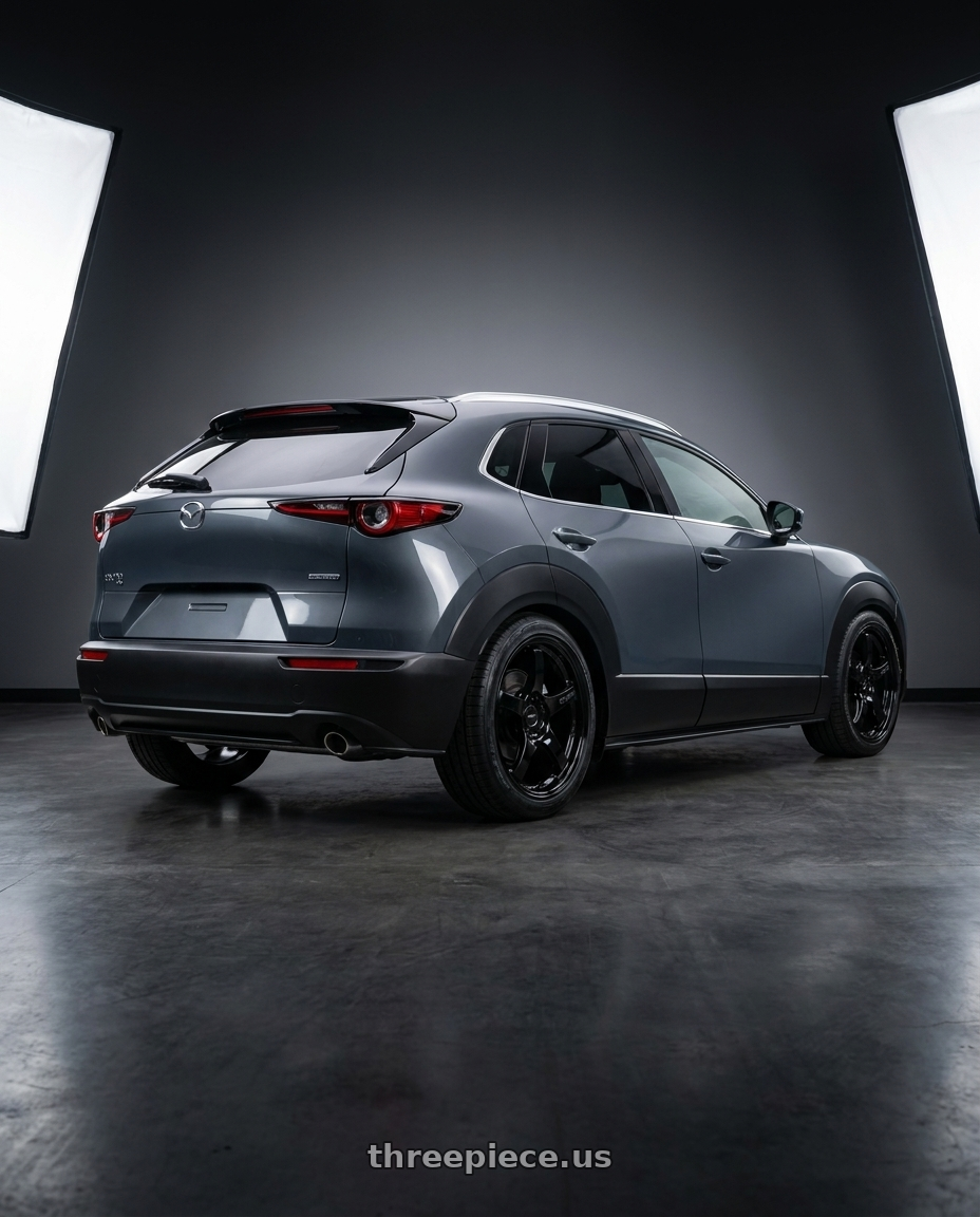 2026 mazda cx30 with Gram Lights 57CR 5x114.3 17x9+12 Glossy Black wheels rear three quarter view square tires