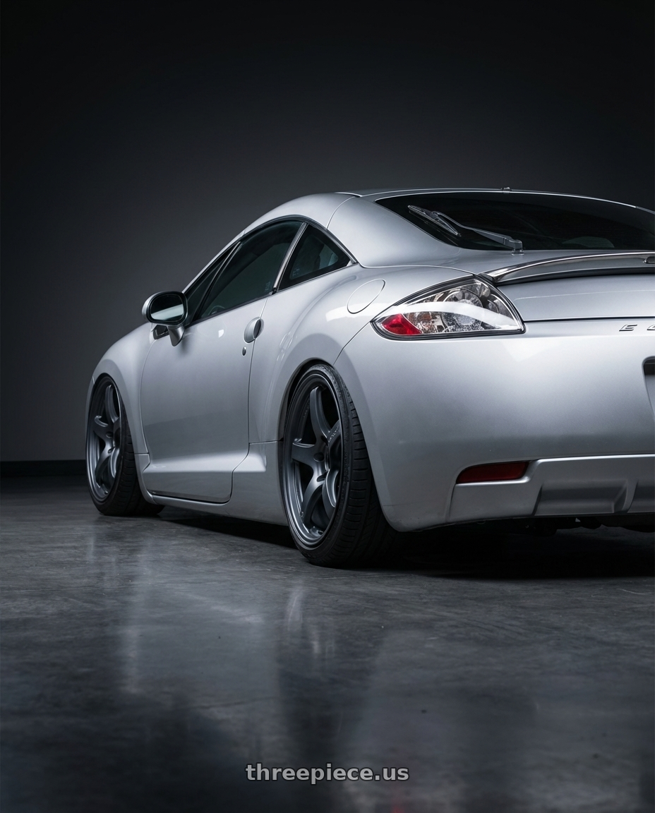 2010 Mitsubishi Eclipse with Gram Lights 57CR 5x114.3 19x10.5+12 Gunblue II wheels rear three quarter view slight stretch tires