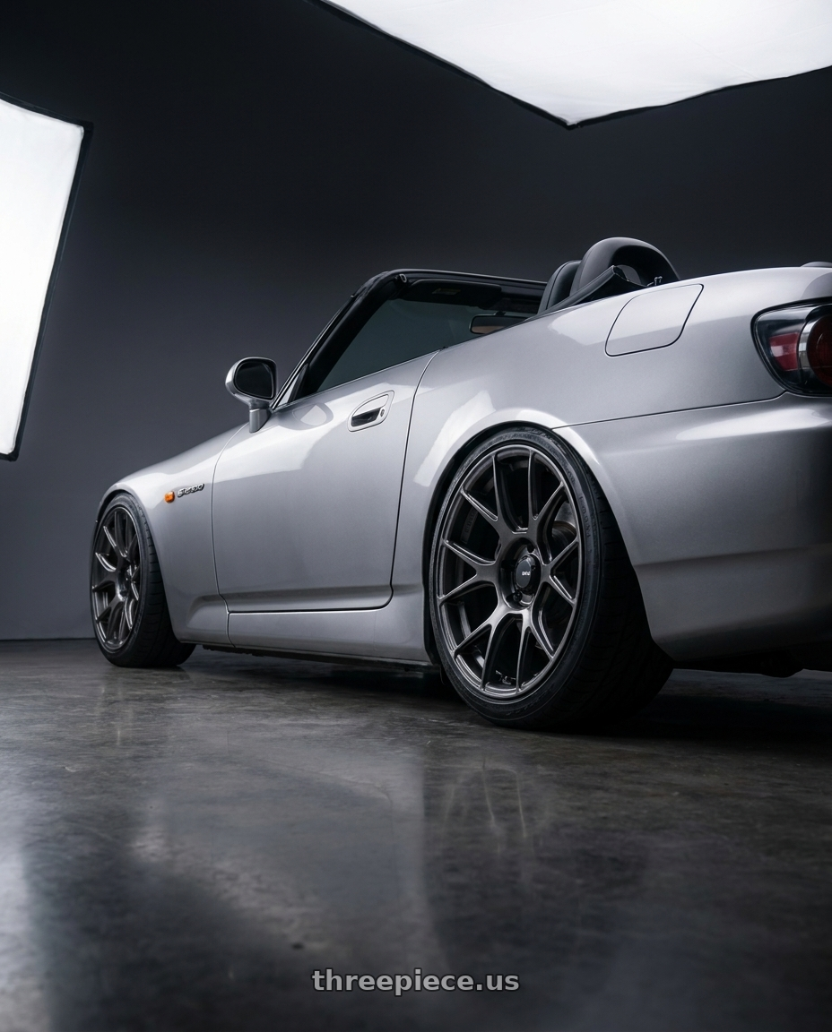 2009 Honda S2000 with Konig Ampliform 5x114.3 18x8.5+45 Dark Metallic Graphite wheels rear three quarter view slight stretch tires