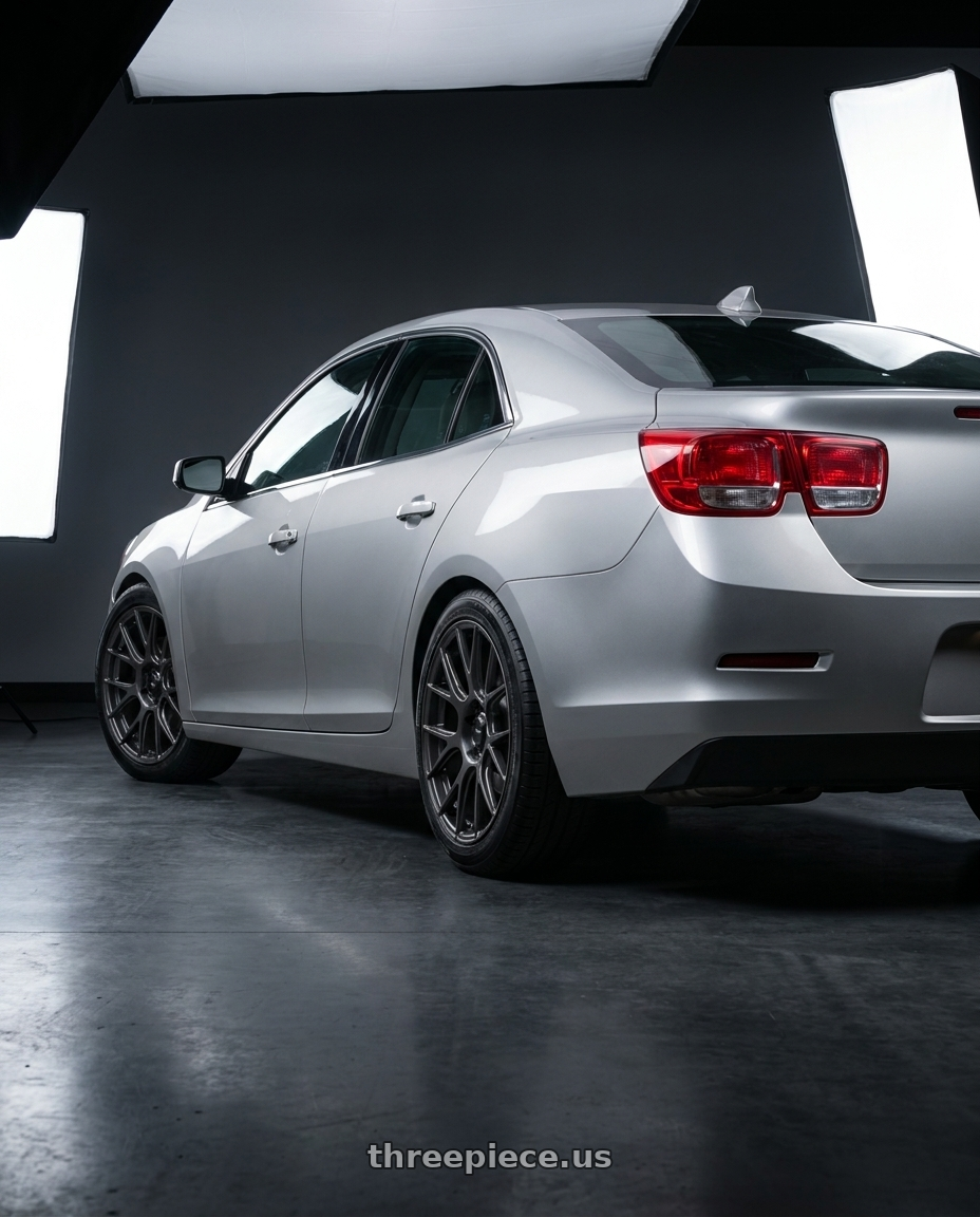 2015 Chevrolet Malibu with Konig Ampliform 5x120 18x8.5+32 Dark Metallic Graphite wheels rear three quarter view square tires
