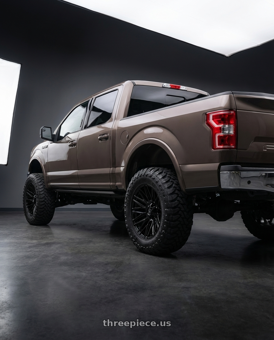 2019 Ford F-150 with Gear Off Road 770B 6X135/6x139.7 22x10 -19 Gloss Black wheels rear three quarter view meaty tires