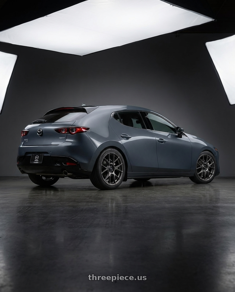 2023 Mazda Mazda3 Turbo with Konig Ampliform 5x114.3 18x9.5+35 Dark Metallic Graphite wheels rear three quarter view square tires