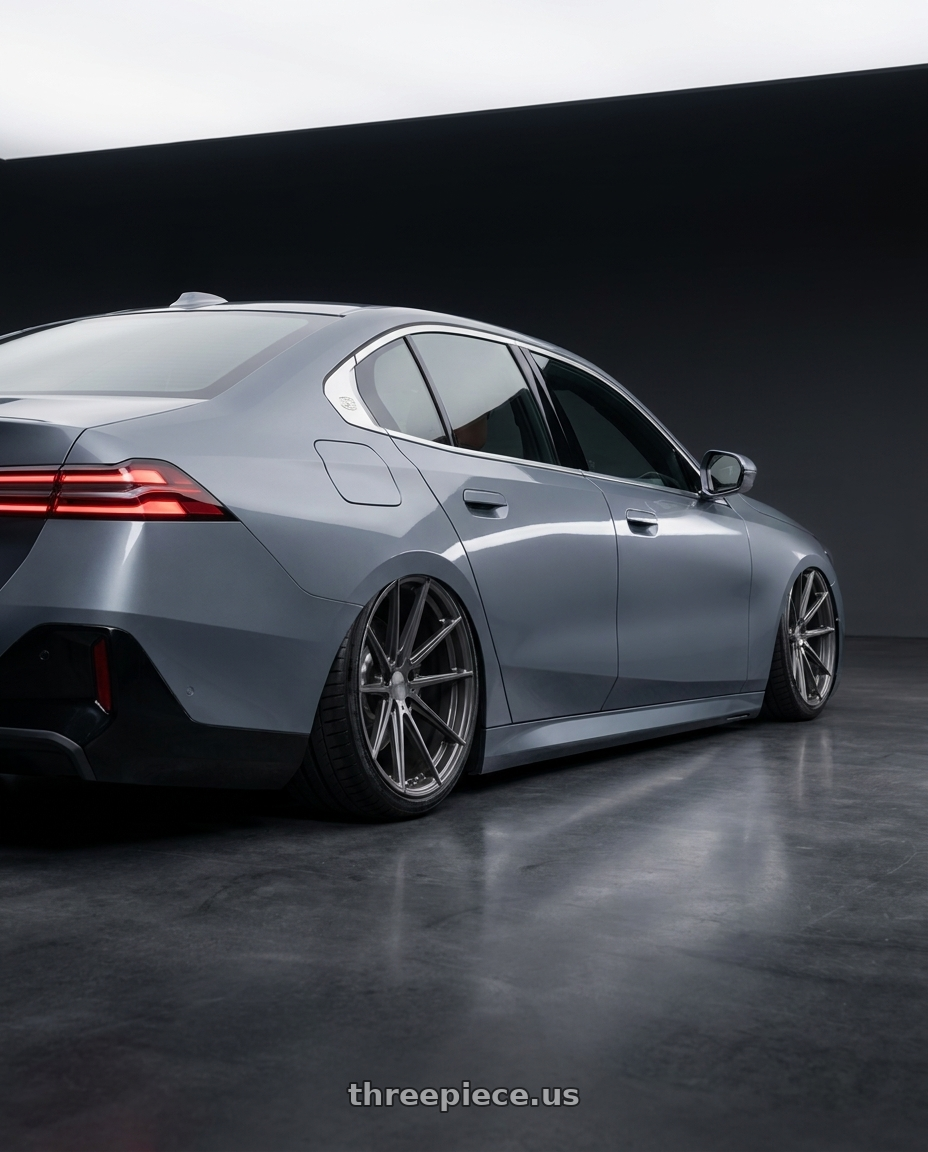 2026 BMW 5-series  with TSW BATHURST 5X100 17X8 +35 GLOSS GUNMETAL wheels rear three quarter view slight stretch tires