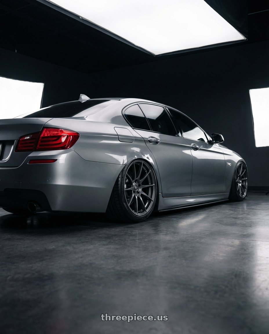 2016 BMW 5 Series F10 with Forgestar CF10 5x120 20x9 +38 Gloss Anthracite wheels rear three quarter view slight stretch tires