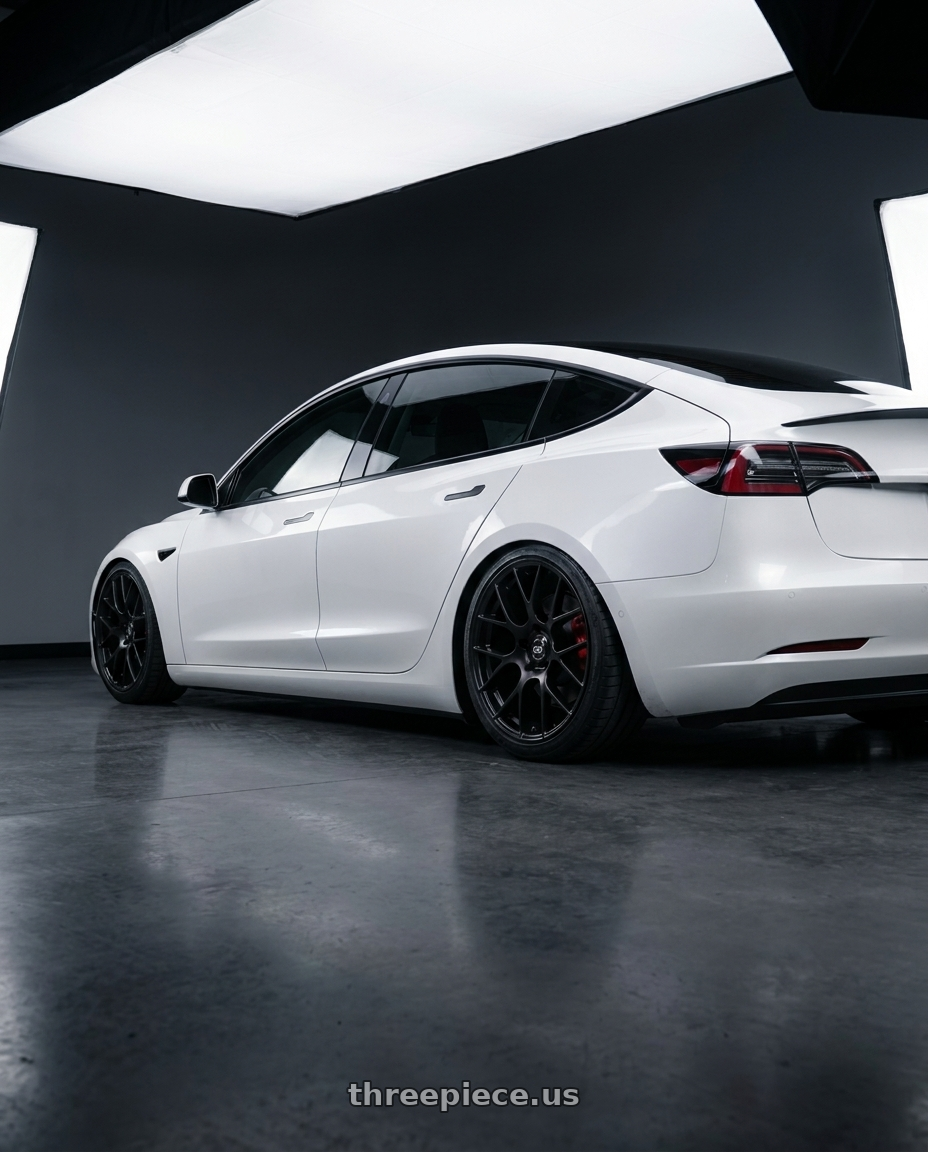 2018 Tesla Model 3 with Enkei Raijin 5x114.3 19x8.5+35 Black wheels rear three quarter view slight stretch tires