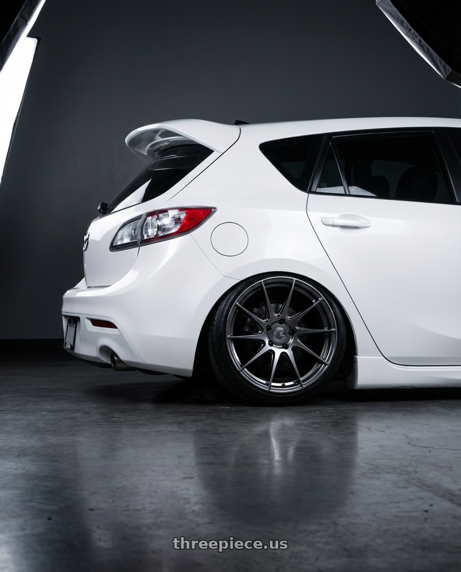 2012 Mazda Mazdaspeed3 with Aodhan AH09 5x114.3 18x8.5 +35 Hyper Black wheels rear three quarter view slight stretch tires