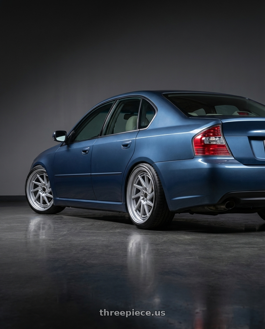 2007 Subaru legacy 2.5i blue with Heritage Wheel Hokkaido-Dir Monoc 5X100 18x9.5+22 Silver wheels rear three quarter view slight stretch tires