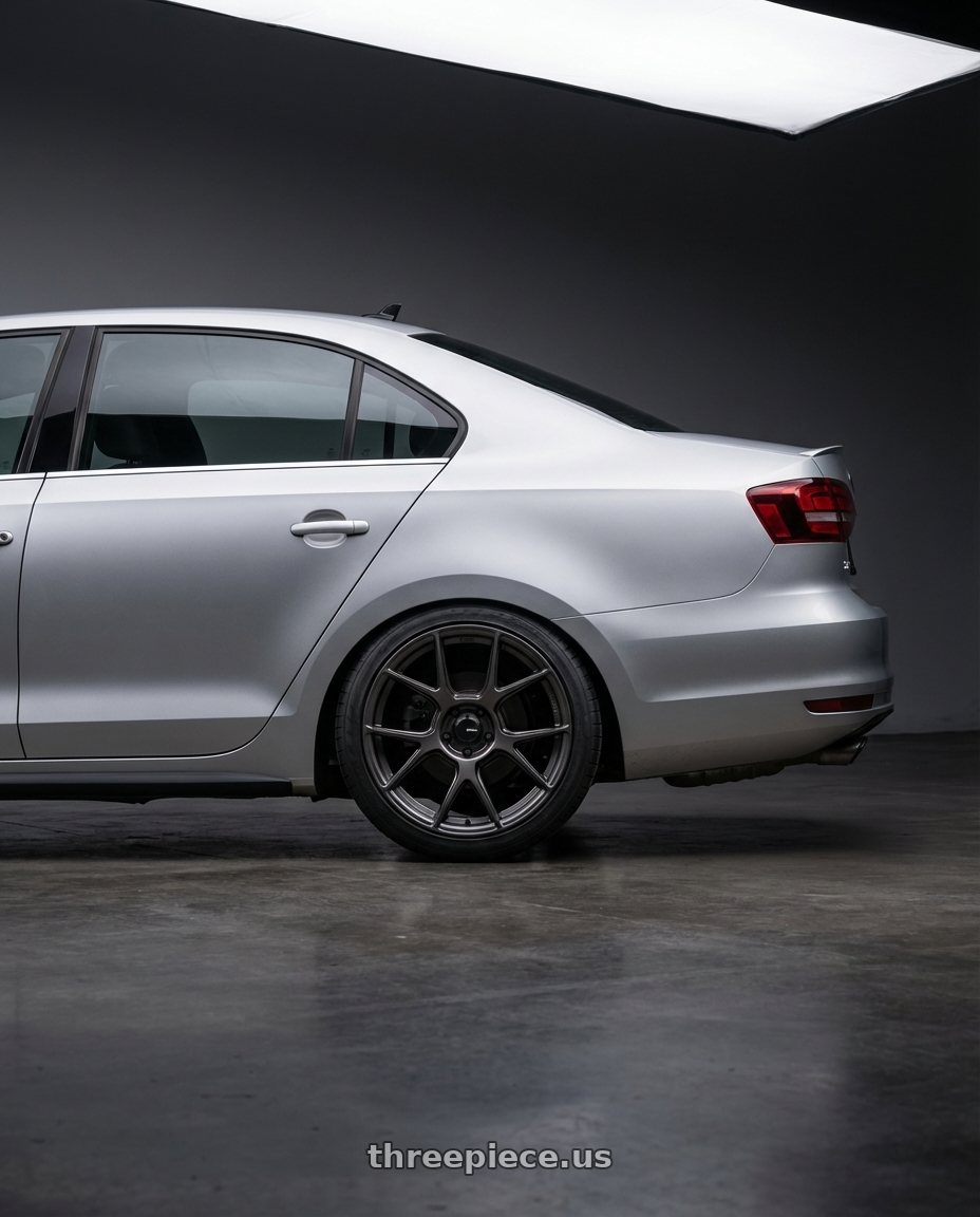 2016 Volkswagen Jetta GLI MK6 with Konig Ampliform 5x112 18x8.5+43 Dark Metallic Graphite wheels rear three quarter view square tires