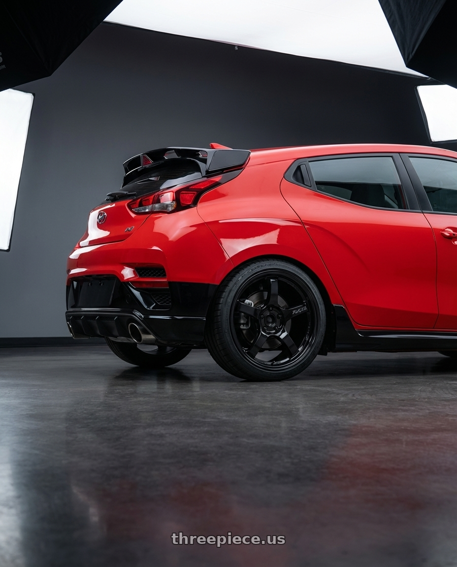 2022 Hyundai Veloster N with Gram Lights 57CR 5x114.3 19x9.5+25 Glossy Black wheels rear three quarter view square tires