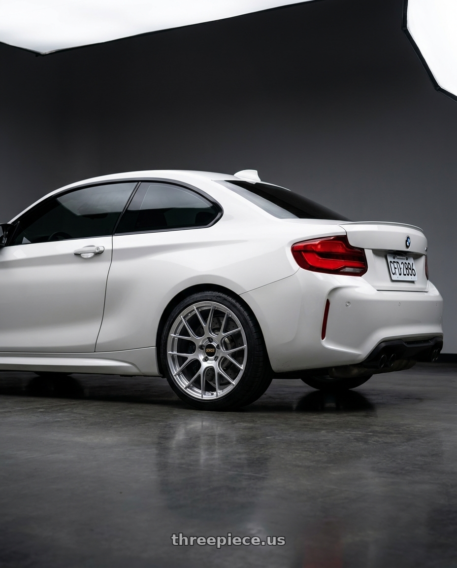 2019 BMW M2 Competition with BBS RE-V7 5x120 19x9.5 +25 Gloss Diamond Silver wheels rear three quarter view square tires
