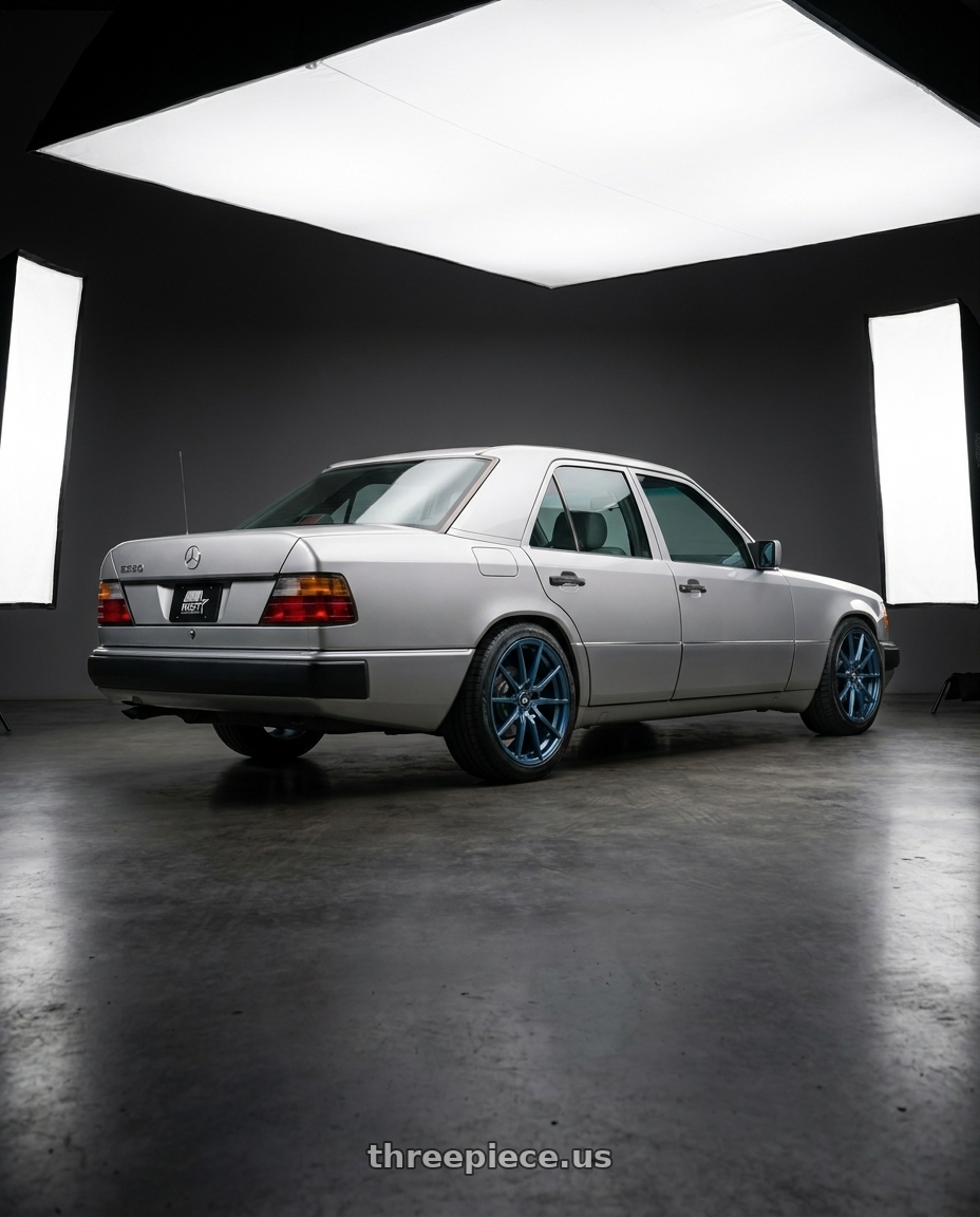 1994 W124 E220 with MST Wheels DELTA 5X112 18X8.5 +43 Cerulean Blue Pearl wheels rear three quarter view square tires