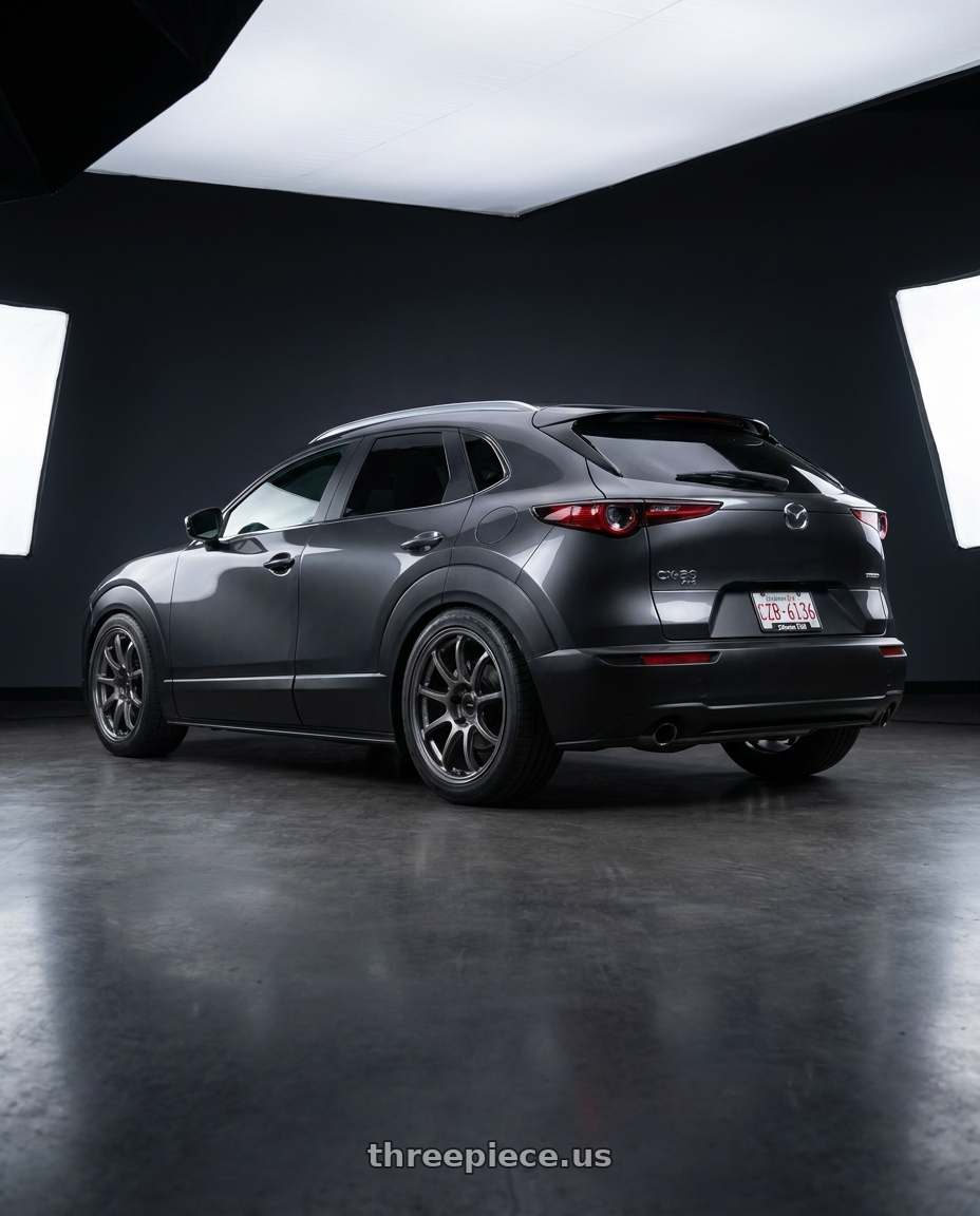 2026 mazda cx30 with Enkei PF09 5x114.3 18x8.5+38 Dark Silver wheels rear three quarter view square tires