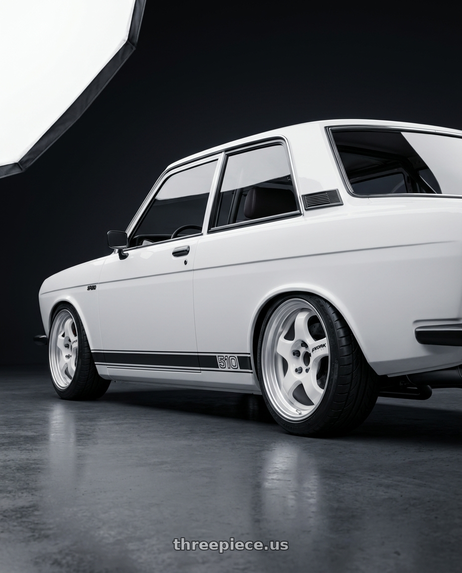 1973 datsun 510 with Work Meister S1 2P 4x114.3 15x7+22 O Disk Black wheels rear three quarter view square tires