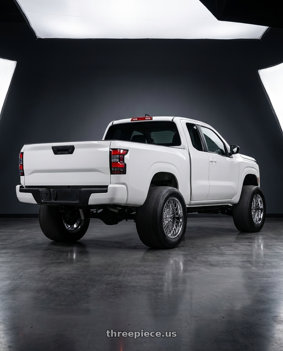 2025 nissan frontier king cab with Strada Spina 5x115/5x120 22x8.5 +15 Chrome wheels rear three quarter view excessive tires