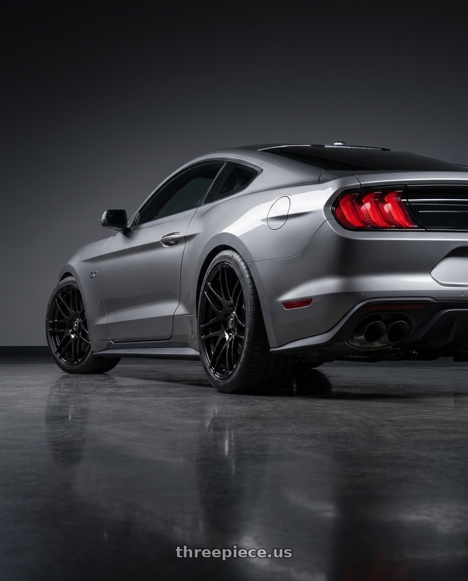 2021 Ford Mustang GT with Forgestar F14 5x114.3 20x9.5 +29 Gloss Black wheels rear three quarter view staggered tires