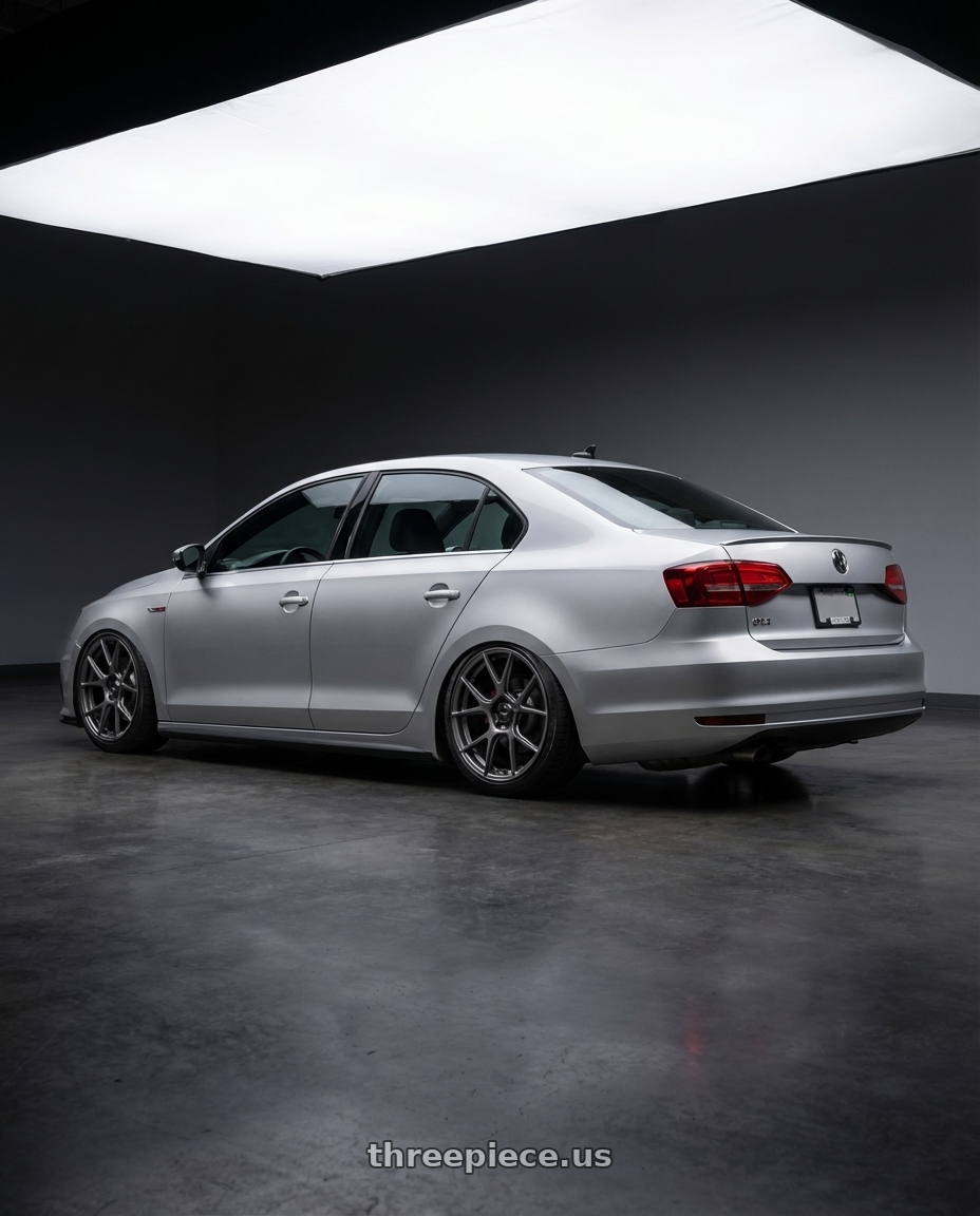 2016 Volkswagen Jetta GLI MK6 with Konig Ampliform 5x112 18x8.5+43 Dark Metallic Graphite wheels rear three quarter view slight stretch tires