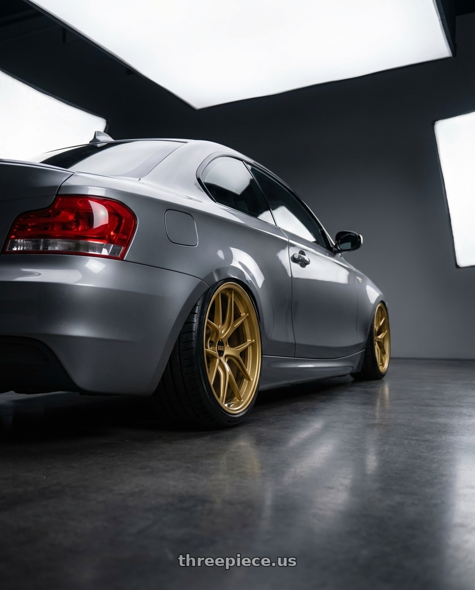 2012 BMW 1 Series E82 with BBS FI-R 5x120 19x10.5+35 Gold wheels rear three quarter view slight stretch tires