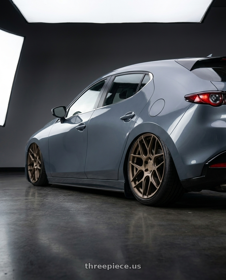 2020 Mazada3 5D with Aodhan AFF2 5x120 19x9.5+35 Matte Bronze wheels rear three quarter view slight stretch tires