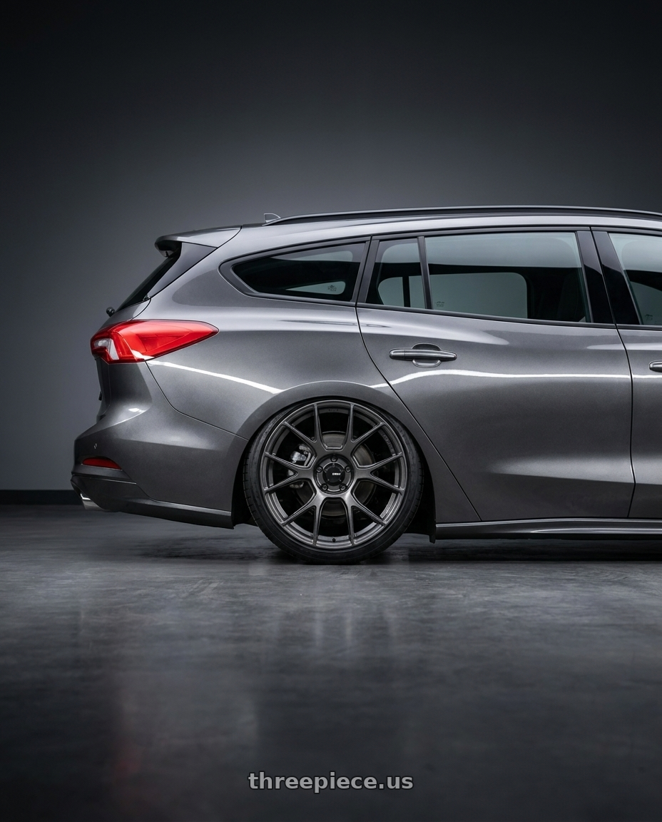 2023 Ford focus st line wagon with Konig Ampliform 5x114.3 19x9.5+25 Dark Metallic Graphite wheels rear three quarter view slight stretch tires