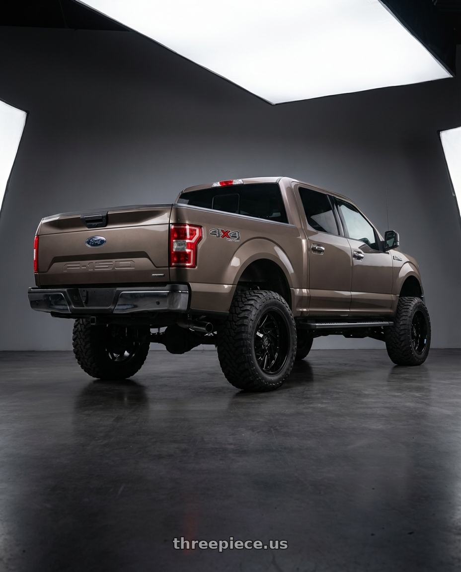 2019 Ford F-150 with Gear Off Road 769B 6X135/6x139.7 22x10 -19 Gloss Black wheels rear three quarter view meaty tires