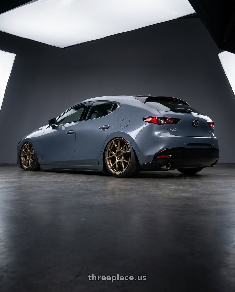 2023 Mazda Mazda3 Turbo with Konig Ampliform 5x114.3 18x9.5+25 Gloss Bronze wheels rear three quarter view slight stretch tires