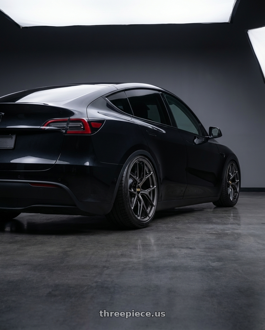 2026 Tesla Model Y Juniper, Diamond Black Metallic with BBS FI-R 5x112 20x11.5+40 Diamond Black wheels rear three quarter view slight stretch tires