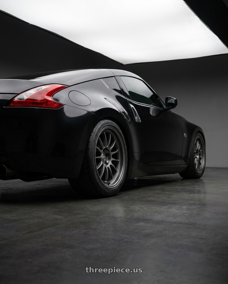 2009 Nissan 370z Magnetic Black Metallic  with Kansei K13G Corsa 5x114.3 18x10.5 12 Gunmetal wheels rear three quarter view meaty tires