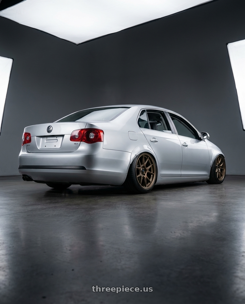 2009 Volkswagen Jetta GLI MK5 with Konig Ampliform 5x112 18x8.5+43 Gloss Bronze wheels rear three quarter view slight stretch tires