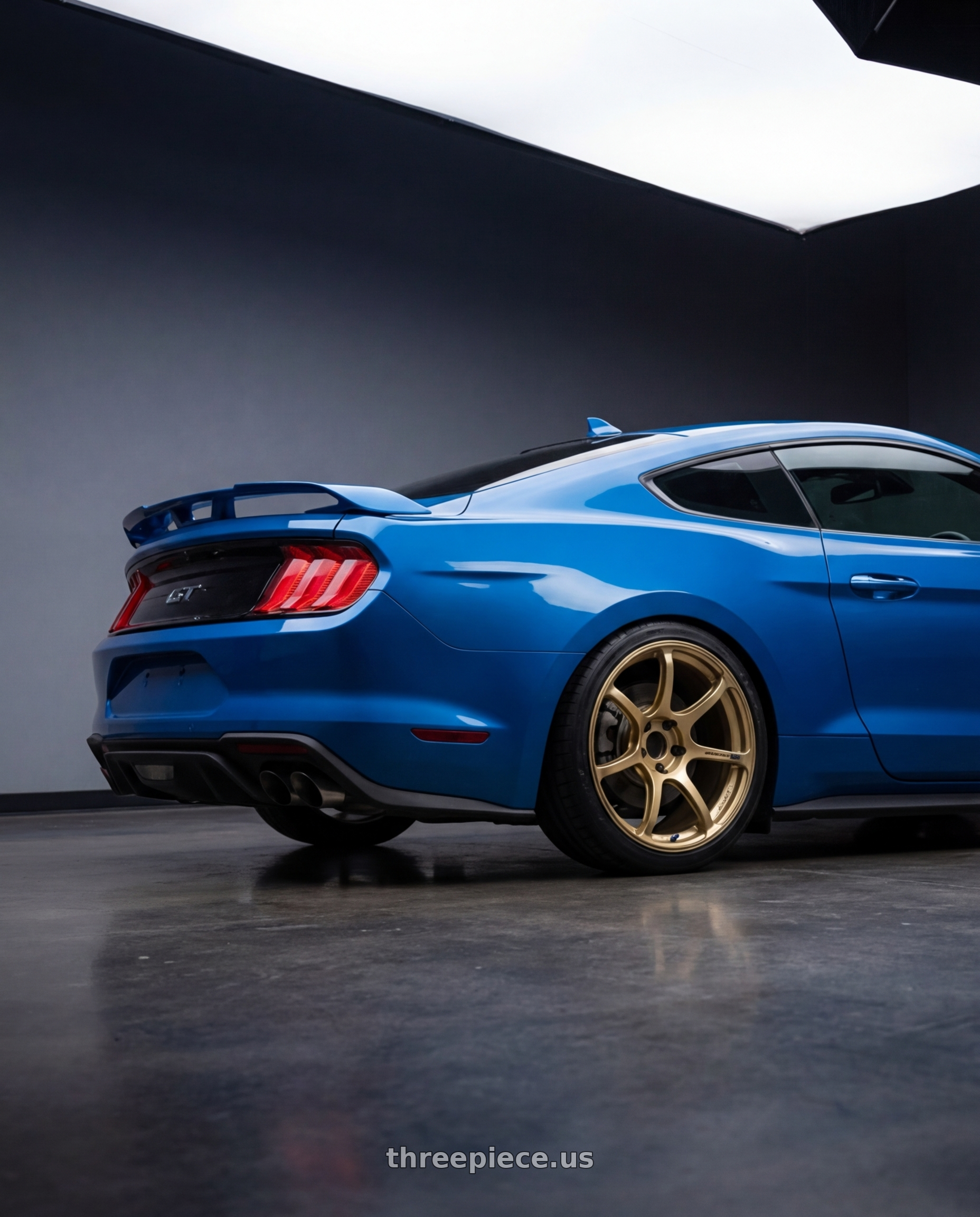 2022 Ford Mustang GT with Advan RGIII 5x114.3 19x10.5+25 Gold wheels rear three quarter view square tires