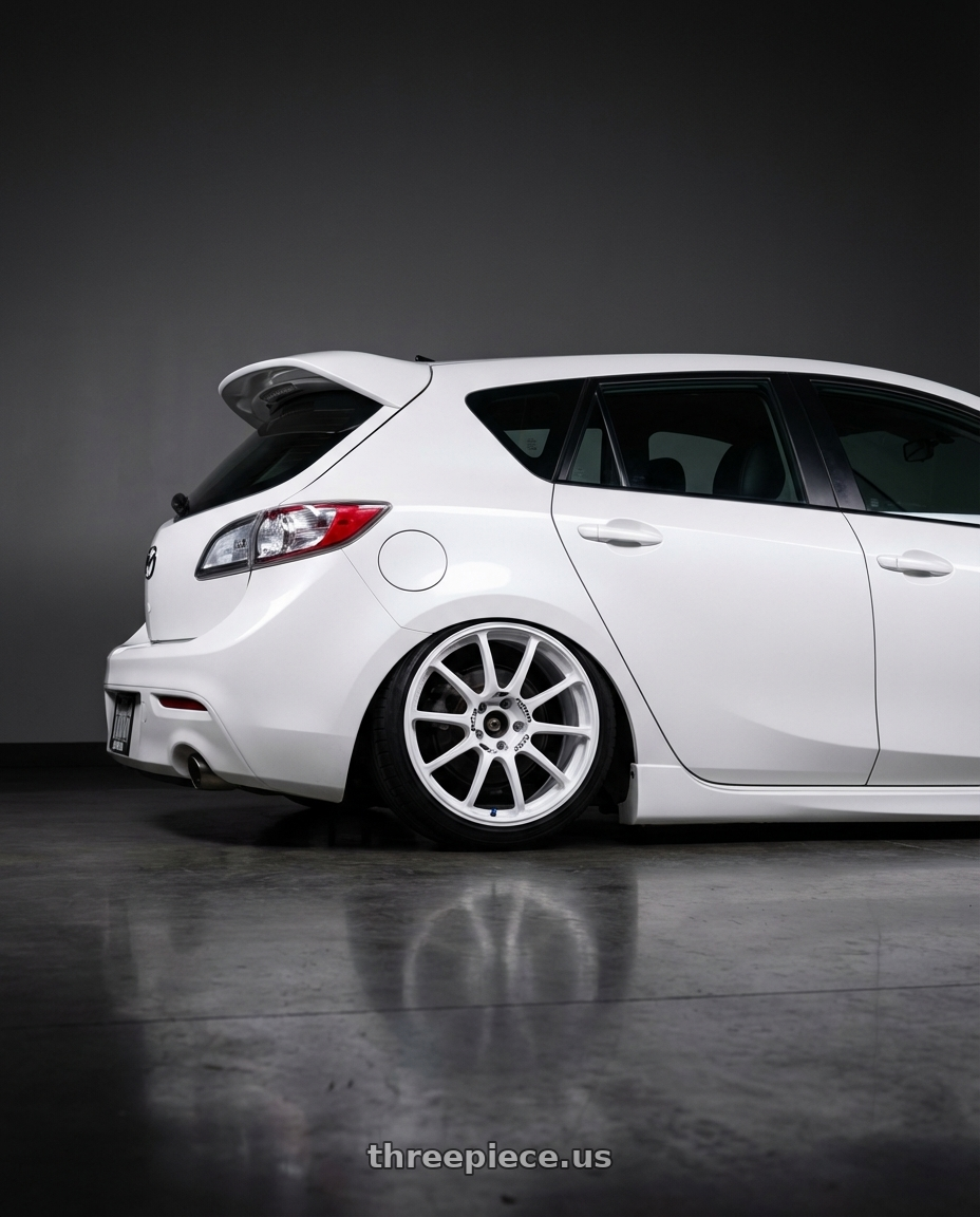 2012 Mazda Mazdaspeed3 with Advan RCIII 5x114.3 18x8.5+38 White wheels rear three quarter view slight stretch tires