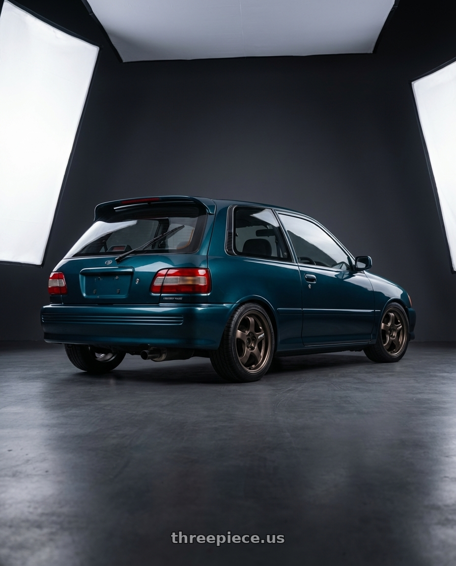 1990 Toyota Starlet GT with Work Meister S1R 4x100 16x7.5+45 A Disk Ashdot Titanium wheels rear three quarter view square tires