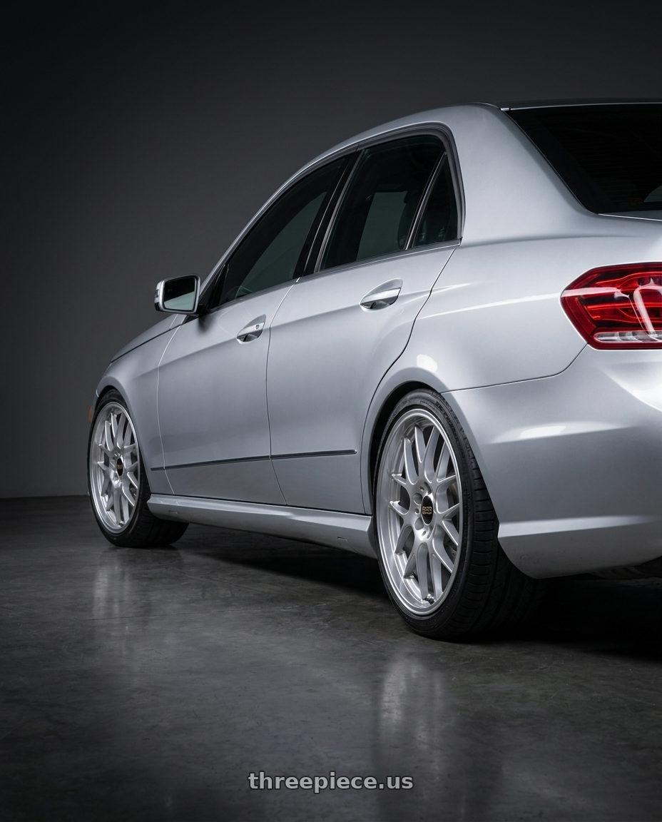 2012 Mercedes E550 with BBS RG-R 5x120 19x9.5+35 Diamond Silver wheels rear three quarter view slight stretch tires