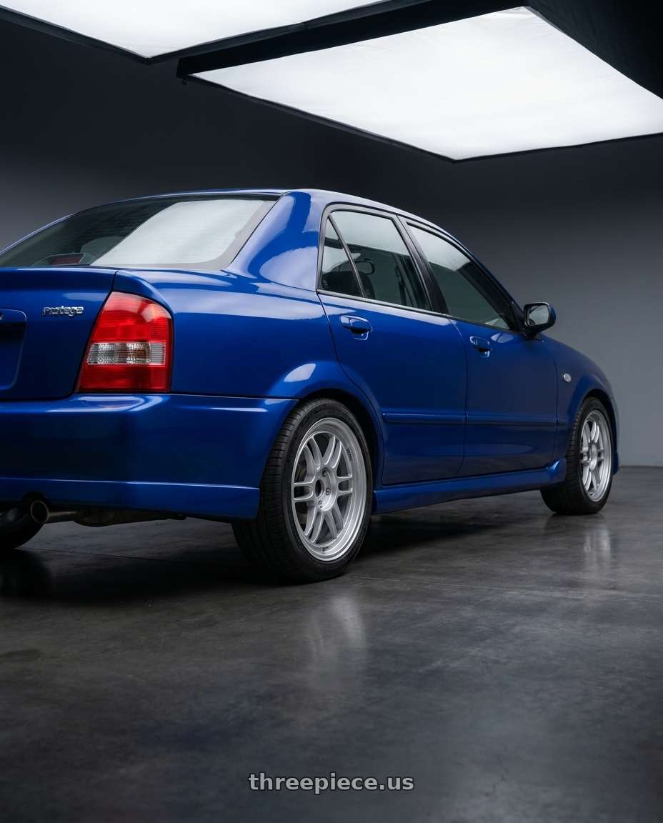 2003 Mazda Protege ES with Enkei RPF1 5x114.3 16x7+43 Silver wheels rear three quarter view square tires